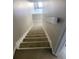 Carpeted staircase leading to upper level at 318 Windrush Blvd # 9, Indian Rocks Beach, FL 33785
