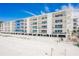 Beachfront building with multiple levels, balconies, and parking at 19610 Gulf Blvd # 409, Indian Shores, FL 33785