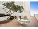Patio table, chairs and grill near building at 19610 Gulf Blvd # 409, Indian Shores, FL 33785