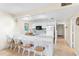 Kitchen features white cabinetry and breakfast bar seating at 19610 Gulf Blvd # 409, Indian Shores, FL 33785