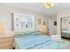 Bedroom with king-size bed, ceiling fan, and ocean-themed bedding at 19610 Gulf Blvd # 409, Indian Shores, FL 33785