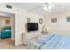 Main bedroom with king-size bed, dresser, and view into second bedroom at 19610 Gulf Blvd # 409, Indian Shores, FL 33785