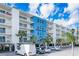 Holiday Villas II building exterior, with parking and landscaping at 19610 Gulf Blvd # 409, Indian Shores, FL 33785