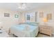 Bedroom with king-size bed, ceiling fan, and two nightstands at 19610 Gulf Blvd # 409, Indian Shores, FL 33785