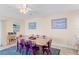 Charming dining room with a rustic wooden table and purple chairs at 19610 Gulf Blvd # 409, Indian Shores, FL 33785
