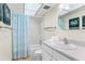 Clean bathroom with shower/tub combo, white vanity, and seashell-themed decor at 19610 Gulf Blvd # 409, Indian Shores, FL 33785