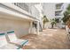 Relaxing patio with lounge chairs near building at 19610 Gulf Blvd # 409, Indian Shores, FL 33785
