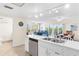 Kitchen with stainless steel dishwasher and view into living room and bathroom at 19610 Gulf Blvd # 409, Indian Shores, FL 33785