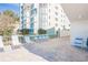Patio with lounge chairs and building view at 19610 Gulf Blvd # 409, Indian Shores, FL 33785