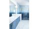 Spa-like bathroom with blue mosaic tile shower and dual vanity at 6700 Burlington N Ave, St Petersburg, FL 33710