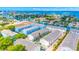 Aerial view displays waterfront condos featuring private balconies, lush landscaping, and convenient parking at 1109 Pinellas Bayway S # 306, Tierra Verde, FL 33715