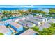 Aerial view of waterfront townhome featuring boat docks, lush landscaping and easy ocean access at 1109 Pinellas Bayway S # 306, Tierra Verde, FL 33715