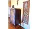 This warm bedroom is accented with hardwood floors and a decorative, vintage armoire at 1109 Pinellas Bayway S # 306, Tierra Verde, FL 33715