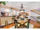 A dining room with a formal table and chairs in front of a kitchen with barstool seating at 1109 Pinellas Bayway S # 306, Tierra Verde, FL 33715