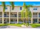 Back of condo showing screened patios, balconies, and a lush green space perfect for relaxation at 1109 Pinellas Bayway S # 306, Tierra Verde, FL 33715