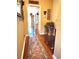 Hallway featuring hardwood floors, an oriental rug, and yellow painted walls at 1109 Pinellas Bayway S # 306, Tierra Verde, FL 33715