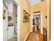 Hallway featuring yellow walls, hardwood floors, and an oriental rug at 1109 Pinellas Bayway S # 306, Tierra Verde, FL 33715