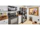 A kitchen with tiled floors, white cabinets, black appliances and dark countertops at 1109 Pinellas Bayway S # 306, Tierra Verde, FL 33715