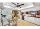 A kitchen and dining area combination featuring tile floors and white cabinets at 1109 Pinellas Bayway S # 306, Tierra Verde, FL 33715