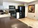 A kitchen with white cabinets and stainless steel appliances, tile floor and dark countertops at 1109 Pinellas Bayway S # 306, Tierra Verde, FL 33715