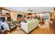 Open-concept living room featuring hardwood floors, comfortable seating, and a view of the kitchen area at 1109 Pinellas Bayway S # 306, Tierra Verde, FL 33715