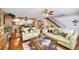 Inviting living room with hardwood floors, comfortable couches, and a decorative staircase at 1109 Pinellas Bayway S # 306, Tierra Verde, FL 33715