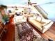 Open concept living area with hardwood floors and staircase with rod iron spindles at 1109 Pinellas Bayway S # 306, Tierra Verde, FL 33715