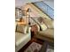 Comfortable and stylish living room featuring a staircase with decorative iron railings and plenty of natural light at 1109 Pinellas Bayway S # 306, Tierra Verde, FL 33715