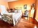 A large bedroom features hardwood floors, a unique accent rug, and a decorative metal bed frame at 1109 Pinellas Bayway S # 306, Tierra Verde, FL 33715