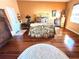 A large bedroom features hardwood floors, a unique accent rug, and a decorative metal bed frame at 1109 Pinellas Bayway S # 306, Tierra Verde, FL 33715