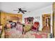 Bedroom featuring built-in shelves, ceiling fan, and a view into the hall at 1109 Pinellas Bayway S # 306, Tierra Verde, FL 33715