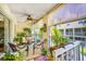 Relaxing patio area with wicker furniture, plants, and a ceiling fan for a comfortable outdoor space at 1109 Pinellas Bayway S # 306, Tierra Verde, FL 33715