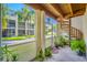 Enjoy this relaxing screened-in patio with a spiral staircase and beautiful views of the community's landscaping at 1109 Pinellas Bayway S # 306, Tierra Verde, FL 33715