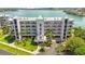 Aerial view of waterfront condo building with lush landscaping at 8001 Sailboat Key S Blvd # 204, St Pete Beach, FL 33707