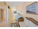 Spacious living area with kitchen views and wicker furniture at 8001 Sailboat Key S Blvd # 204, St Pete Beach, FL 33707