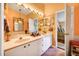 Bathroom with double sinks and a view into bedroom at 1109 Pinellas Bayway S # 306, Tierra Verde, FL 33715