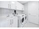 Laundry room with white cabinets, sink, and Whirlpool washer/dryer set at 301 1St S St # 2905, St Petersburg, FL 33701
