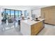 Modern kitchen with island, stainless steel appliances, and light wood cabinets at 301 1St S St # 2905, St Petersburg, FL 33701