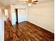 Spacious bedroom featuring wood-look floors and ample closet space at 5816 Congress St # 104, New Port Richey, FL 34653