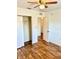 Bedroom with wood-look floors and a double door closet at 5816 Congress St # 104, New Port Richey, FL 34653