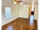 Simple living room with wood-look floors and ceiling fan at 5816 Congress St # 104, New Port Richey, FL 34653