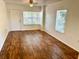 Bright living room featuring wood-look floors and a ceiling fan at 5816 Congress St # 104, New Port Richey, FL 34653