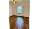 Bright bedroom with wood-look floors and a window with blinds at 5816 Congress St # 104, New Port Richey, FL 34653