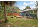Spacious backyard featuring a wood deck, privacy fence and a charming exterior of the home at 49 W Boyer St, Tarpon Springs, FL 34689