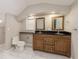 Cozy bathroom features a dual sink vanity, toilet and tile floors with natural light from a window at 49 W Boyer St, Tarpon Springs, FL 34689