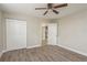 Bedroom with wood-look floors, closet, and neutral walls at 49 W Boyer St, Tarpon Springs, FL 34689
