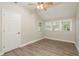 Cozy bedroom features neutral walls, ceiling fan, and wood-look floors with natural light from multiple windows at 49 W Boyer St, Tarpon Springs, FL 34689