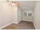 Bright bedroom features wood-look floors and neutral walls with natural light from multiple windows at 49 W Boyer St, Tarpon Springs, FL 34689
