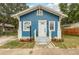 Charming blue house features a well-manicured front yard, white trim and a welcoming front porch at 49 W Boyer St, Tarpon Springs, FL 34689