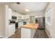 Well-lit kitchen featuring white cabinets, granite countertops, and stainless-steel appliances at 49 W Boyer St, Tarpon Springs, FL 34689